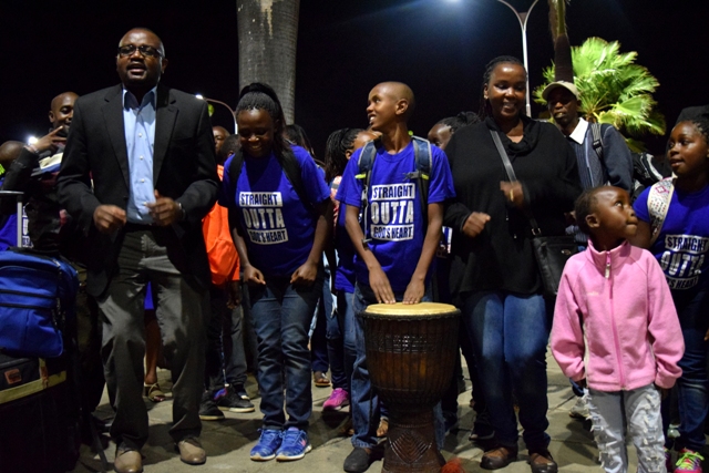 ABC Bank Head of Diaspora Banking (left) dances with some of the children from Upendo Children’s Home at the Jomo Kenyatta International Airport