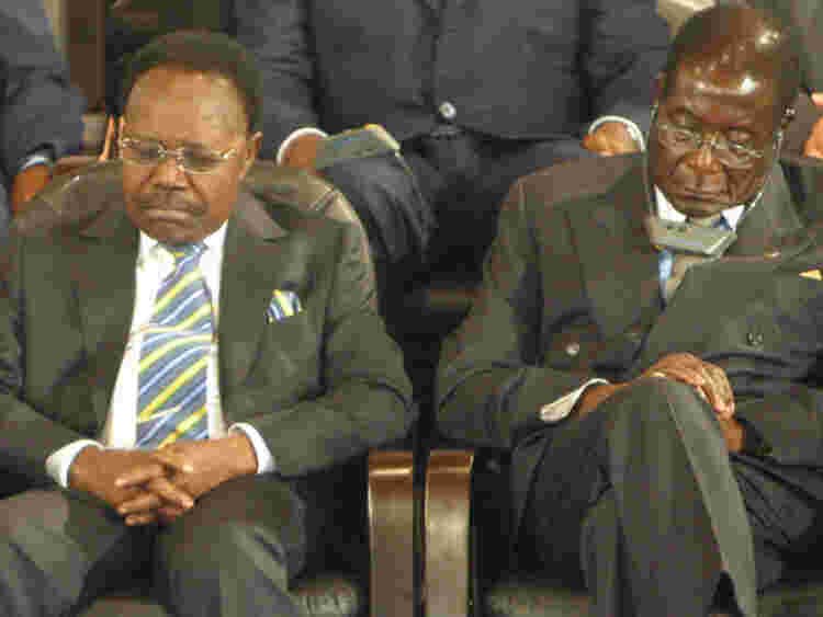 Asleep or resting? Mr Mugabe pictured with former Gabon president Omar Bongo