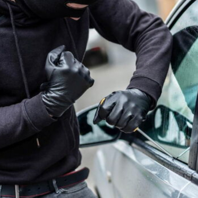 Someone Trying to Break into a Parked car How Criminals in Kenya Use Signal Jammers to Steal Vehicles Without a Trace