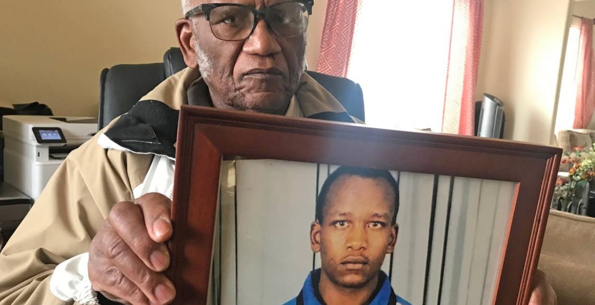 Eliud Ibirthi holds a photo of his son, Kelvin | Matt Driscoll matt.driscoll@thenewstribune.com Family of a Homeless Kenyan Man Found Dead in Tacoma, Washington Speaks