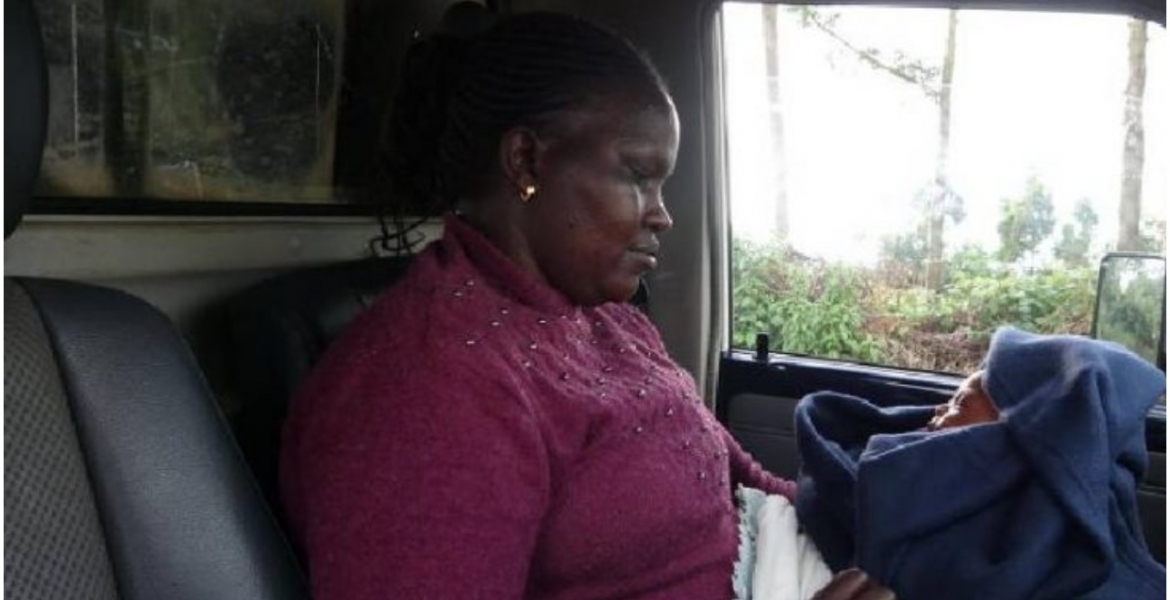 A gender affairs officer from Kericho police station holding the baby bought by Patricia Husband Hands Wife to Police for Buying a Baby After Faking Pregnancy for 9 Months