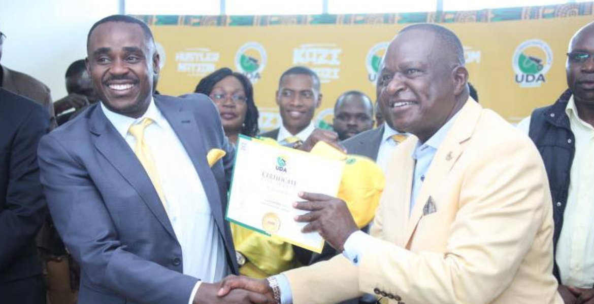 Cleophas Malala Hands Over a Certificate to Former Kisumu Senator Frederick Outa Otieno UDA Ramps Up Campaign to Challenge ODM's Influence in Nyanza