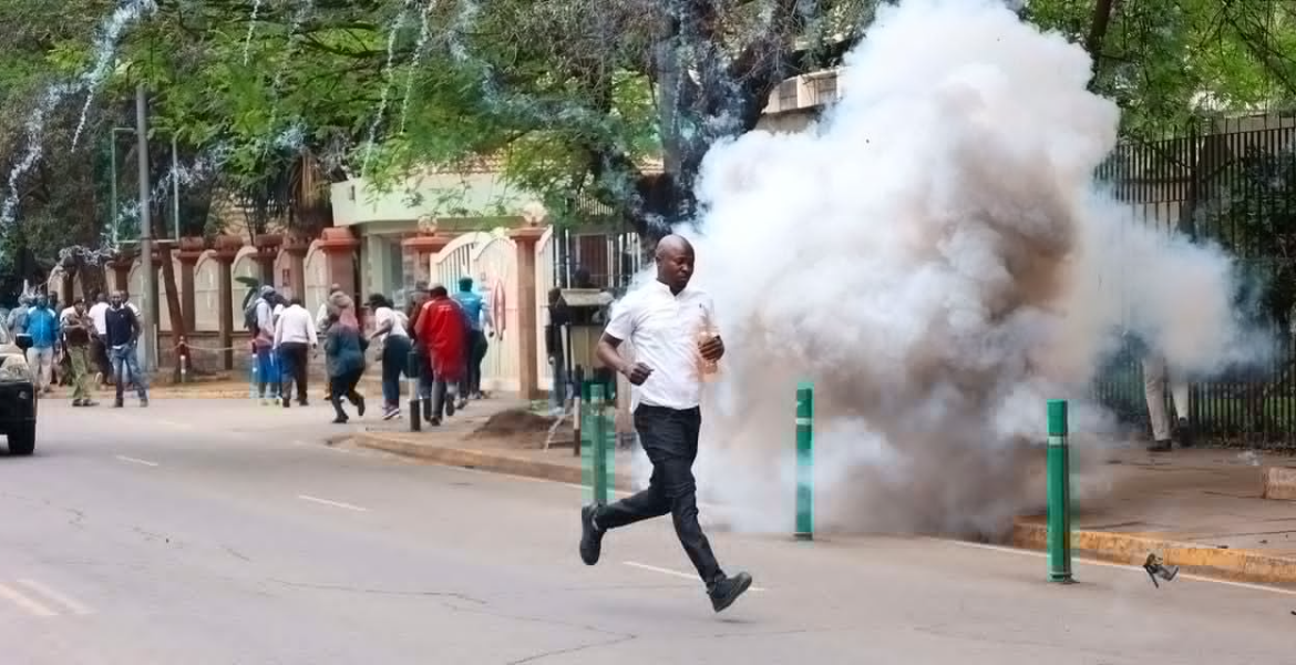 A Protester Runs Past Teargas Smoke Along Harambee Avenue in Nairobi Nairobi Police Detain Lectures Before Parliament March