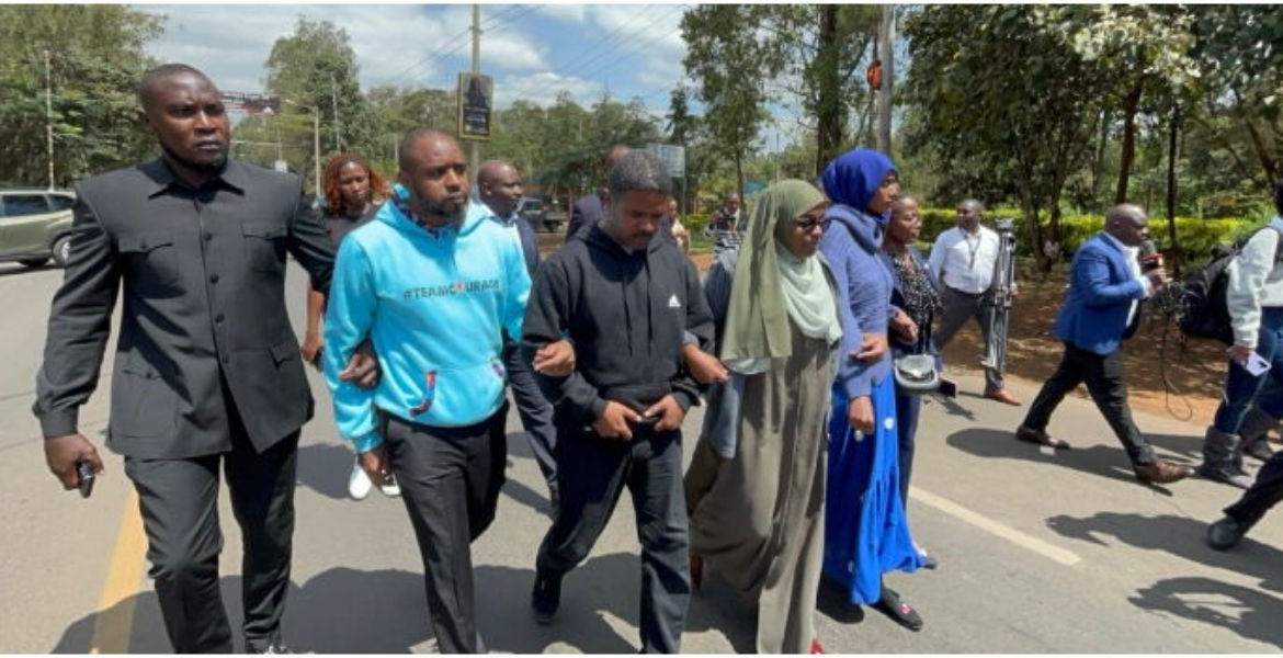 Human Rights Activists Boniface Mwangi and Hussein Khalid Activists Shield Boniface Mwangi from Arrest During Nairobi Protest