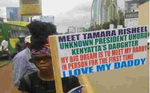 Photo of a Placard Carrying Woman Claiming to be President Uhuru's 'Uknown' Daughter Goes Viral Online